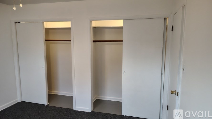 A room with two closets and a door.