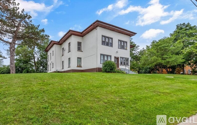 A house with a porch and a sign that says "available" in the front yard.