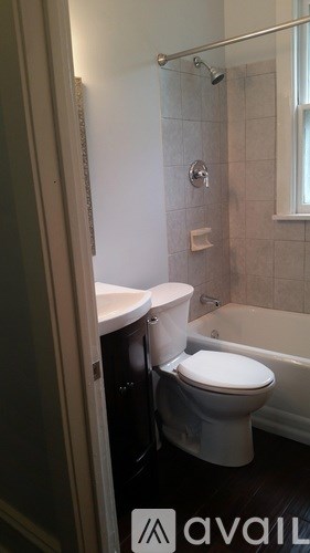 A white toilet in a bathroom with a glass shower door.