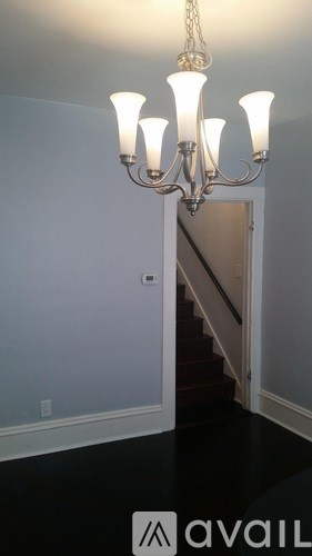 A chandelier hangs over a staircase in a home.