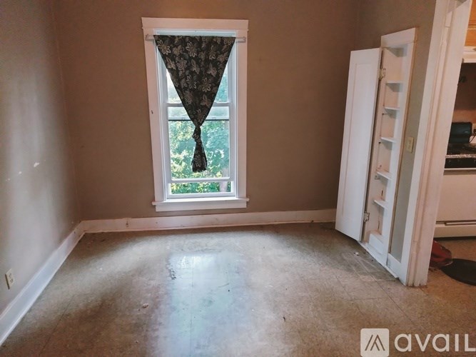 A room with a window and a white door.