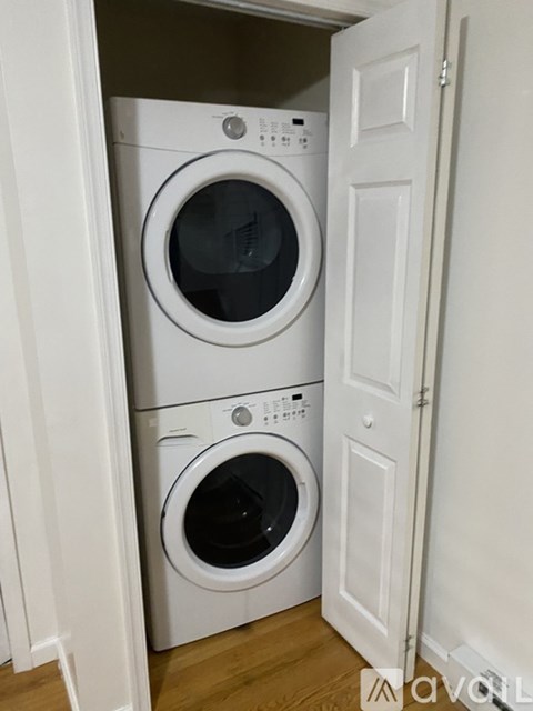 A white washing machine and dryer in a small laundry room.