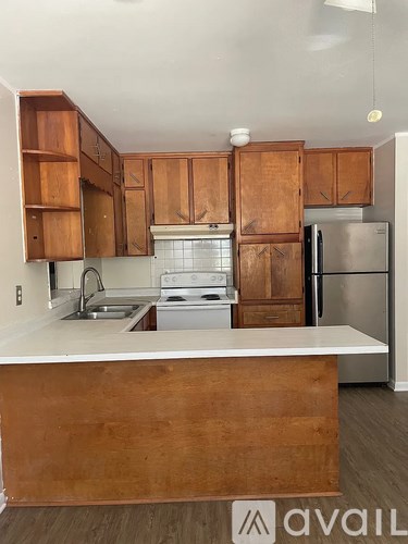A kitchen with wooden cabinets and a white countertop.