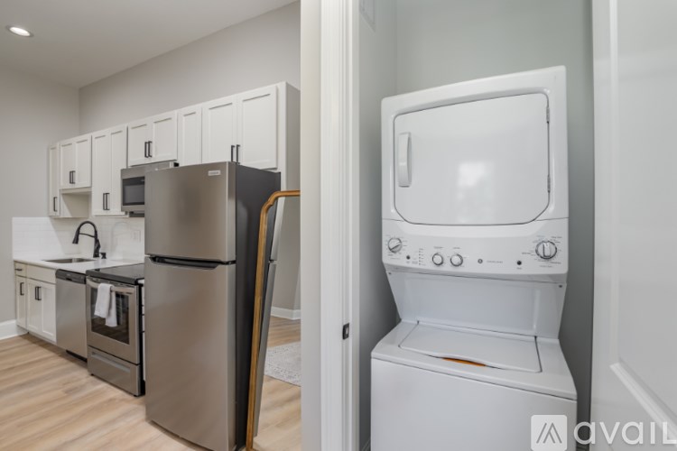 A kitchen with a fridge, oven and microwave.