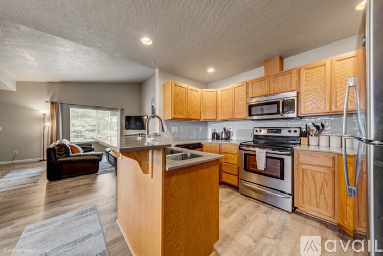 A kitchen with wooden cabinets and stainless steel appliances.