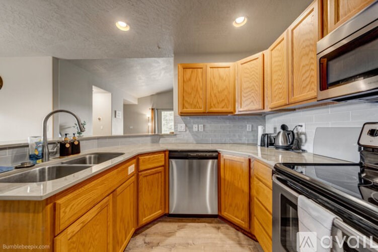 A kitchen with wooden cabinets and stainless steel appliances.