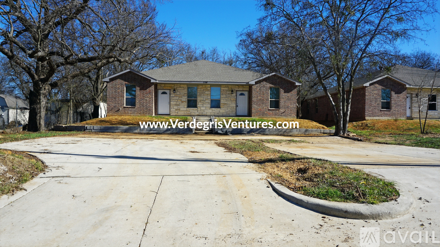 A house with a lawn in front and a sign that says www.verdigrisventures.com.