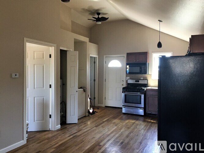 A kitchen with a black refrigerator, a microwave, a stove, and a dishwasher.