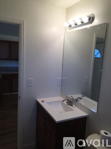 A bathroom with a sink and mirror.