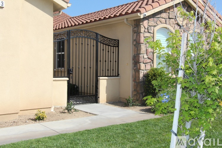 A house with a black gate and a brown roof.