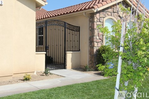A house with a black gate and a brown roof.