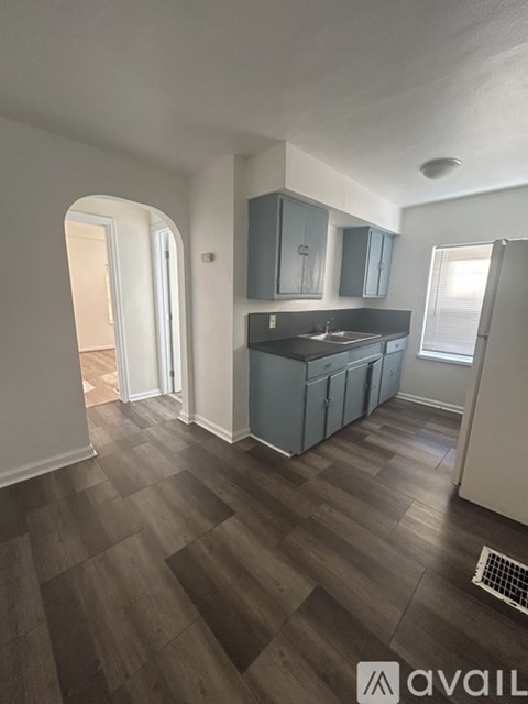 A kitchen with wooden floors and a sink.