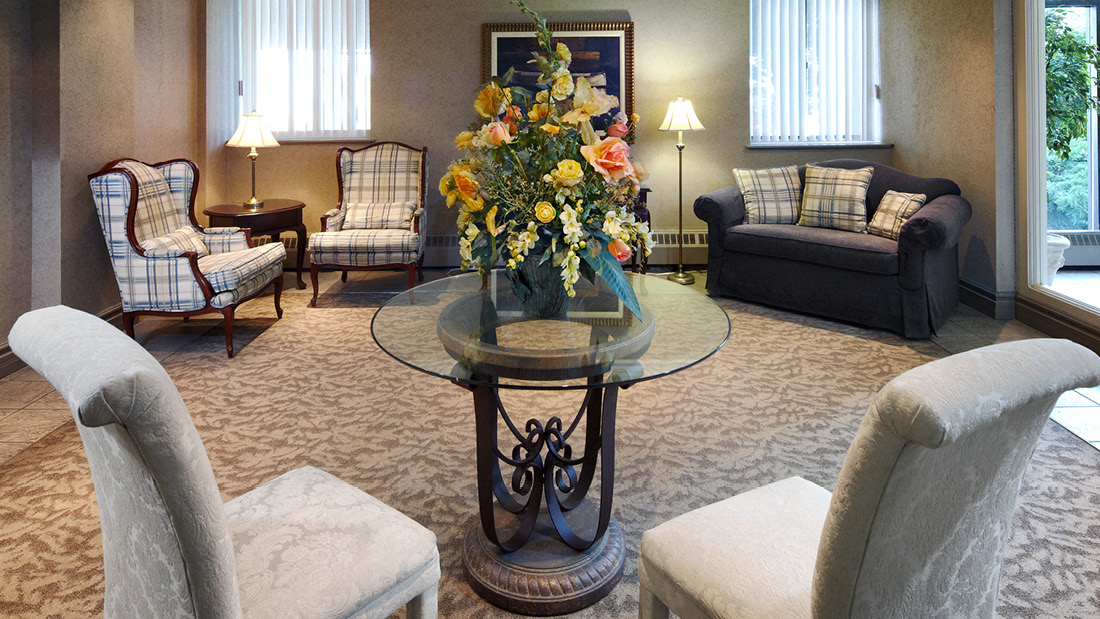 a living room filled with furniture and a vase of flowers