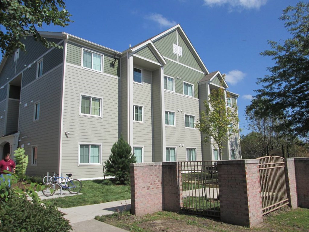 Apartment building with a green lawn in front.