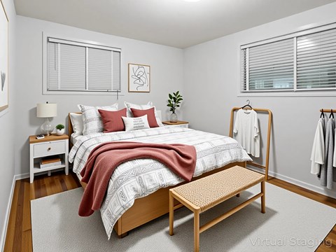 A bedroom with a bed, nightstand, and a bench.