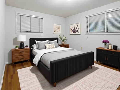 A bedroom with a large bed, a nightstand, and a dresser.