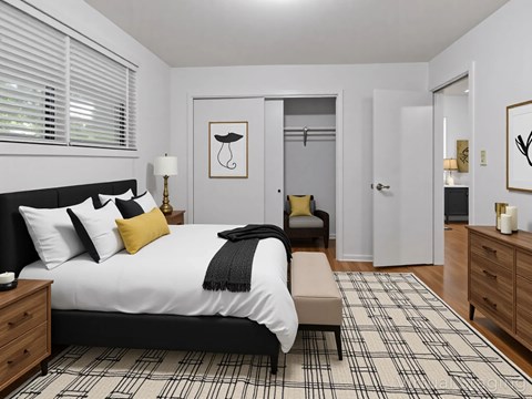 A bedroom with a large bed and a chair.