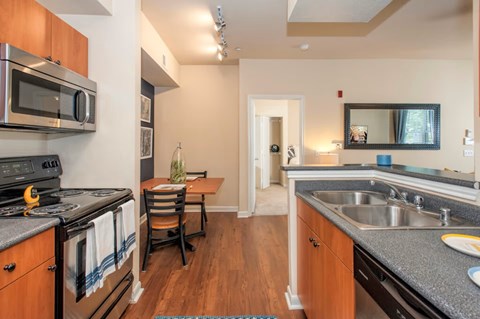 A kitchen with a stove top oven and microwave.