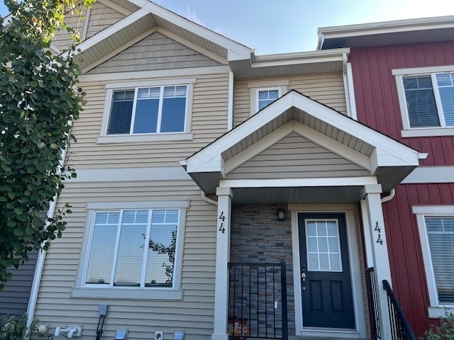 A house with a black front door and a small porch.