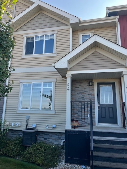 A house with a black gate and a grey door.