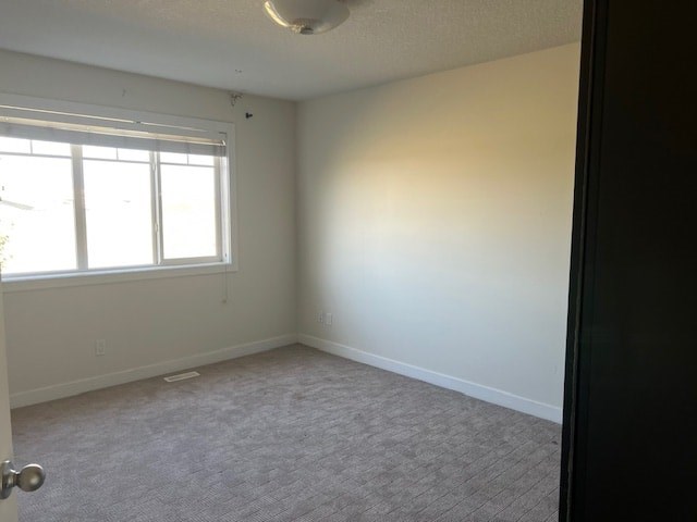 A room with a carpeted floor and a window.