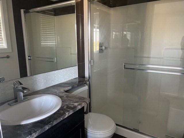 A bathroom with a sink, toilet and shower.