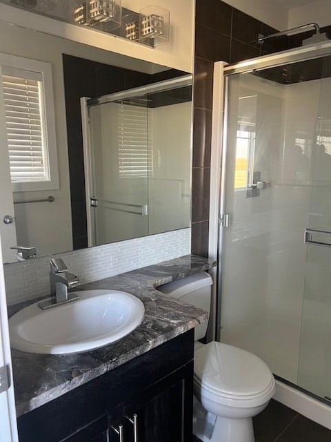 A white toilet sits in a bathroom next to a sink.