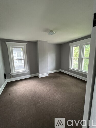 A room with grey walls and carpeted floor.