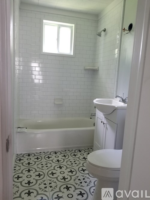 A bathroom with a toilet, sink, and bathtub.