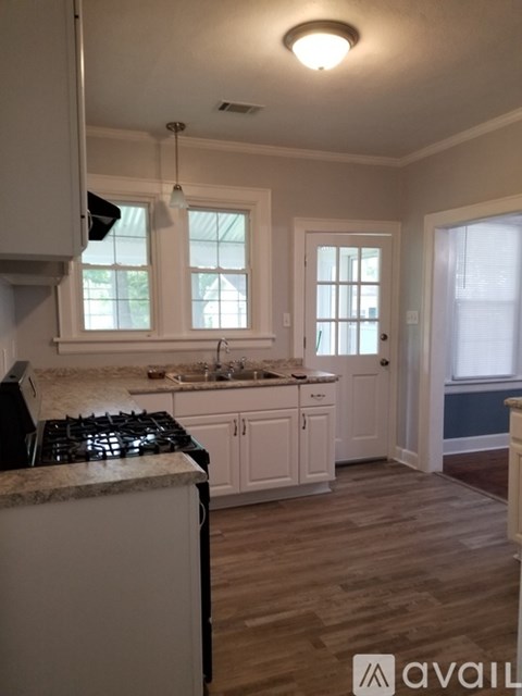 A kitchen with a white stove top oven and a white counter top.