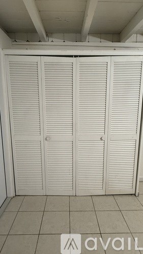 Closed white doors in a room.