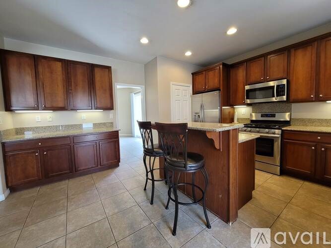 A room with a ceiling fan and carpeted floor.