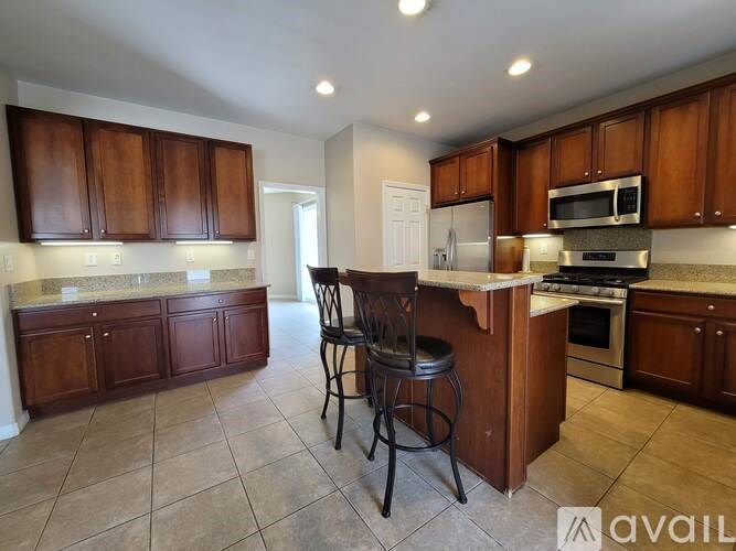 A room with a white door and a window with blinds.