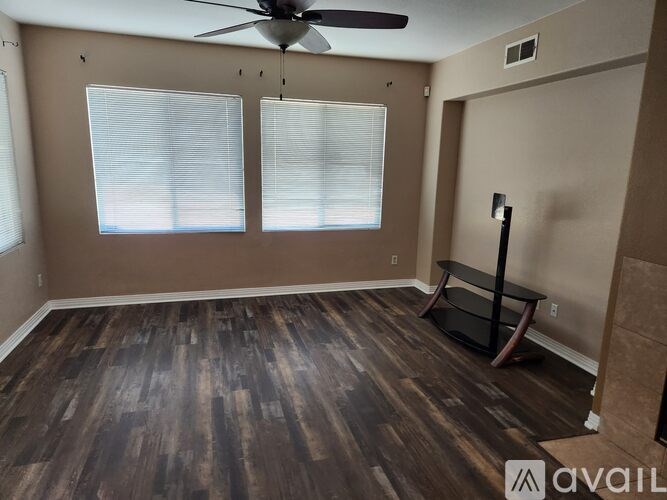 A room with a bench and two windows.