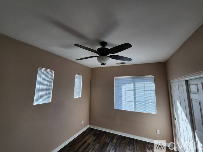 A room with a window and carpeted floor.