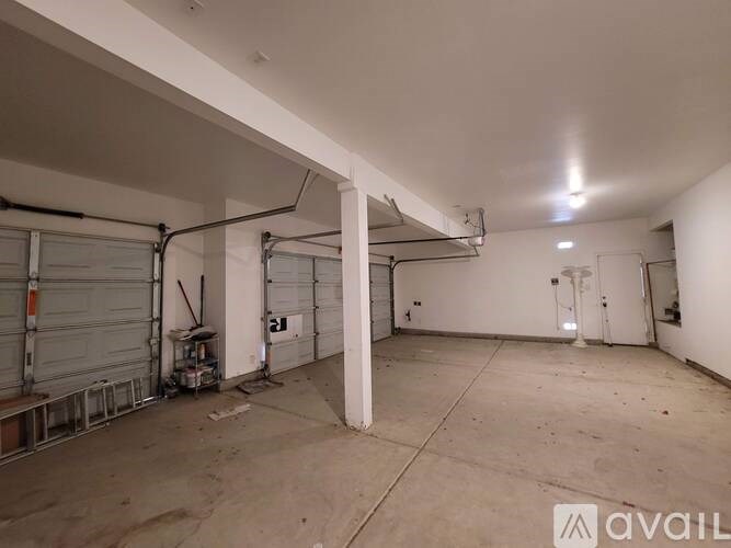 A spacious garage with a concrete floor and white walls.
