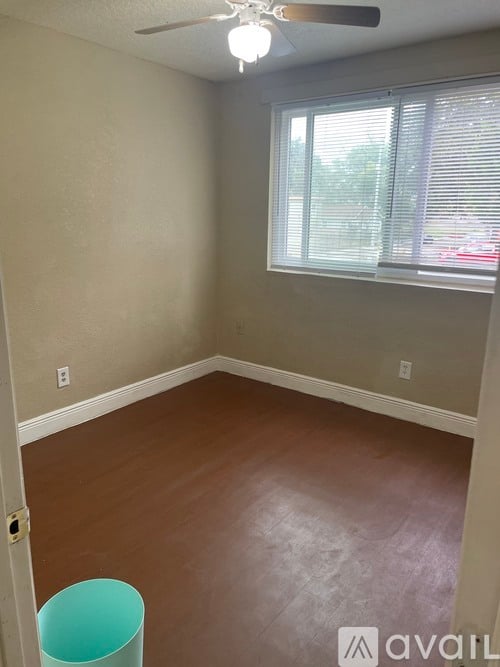 A room with a window and a fan.