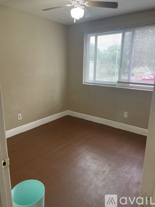 A room with a window and a fan.