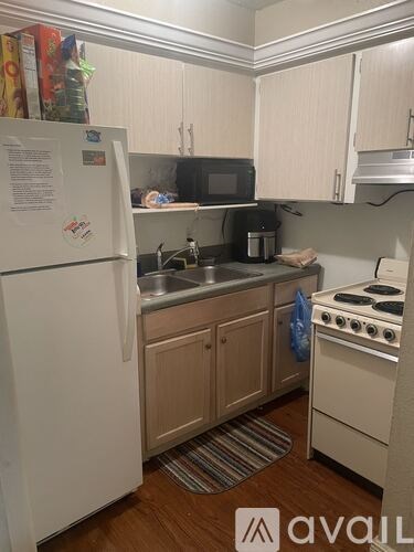 A kitchen with a white fridge and a white stove.