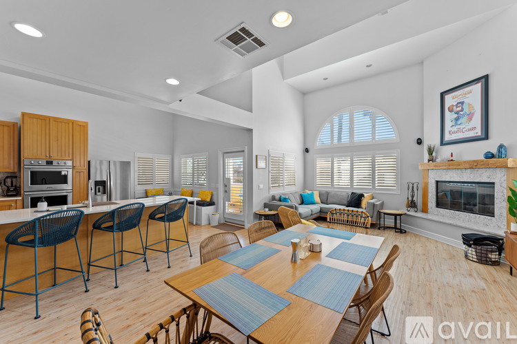 A modern kitchen with a dining table and chairs.