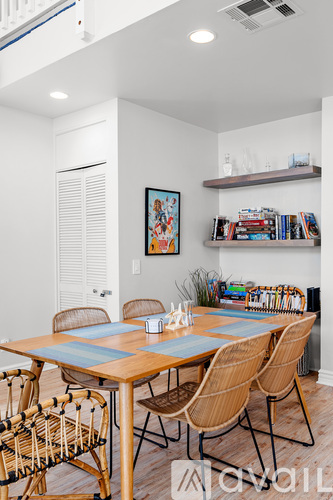 A dining room with a wooden table and chairs.