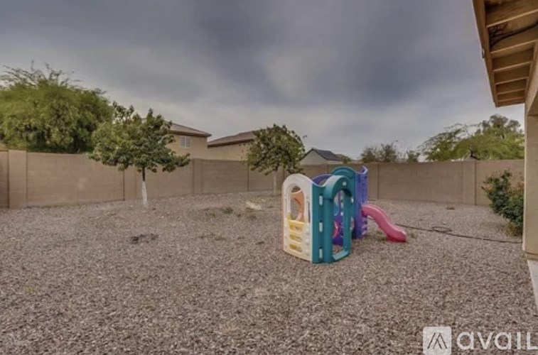 A playground with a slide and a ball pit in the foreground.
