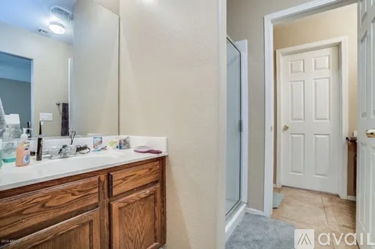 A bathroom with a white door and a white sink.