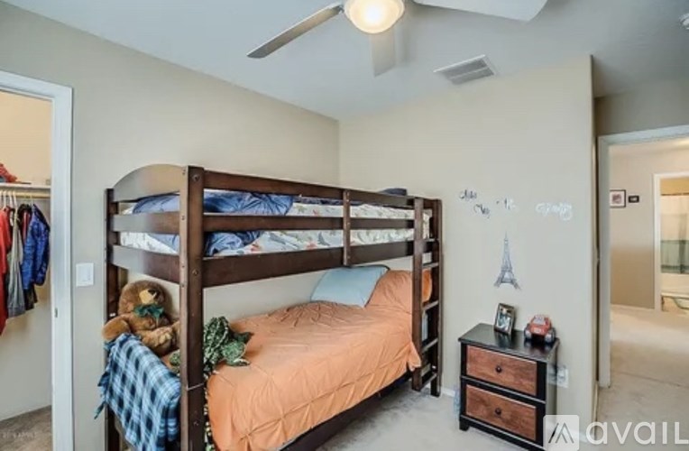 A bedroom with a bunk bed and a dresser.