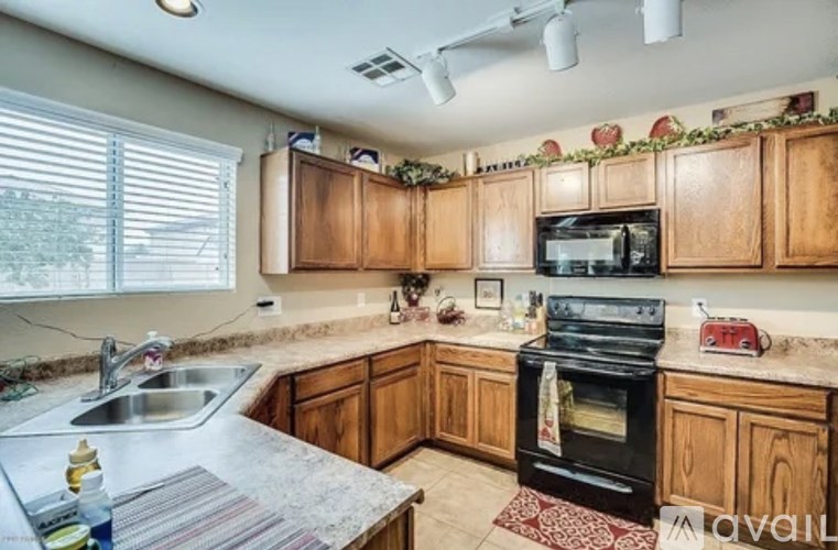 A kitchen with wooden cabinets and a black oven.