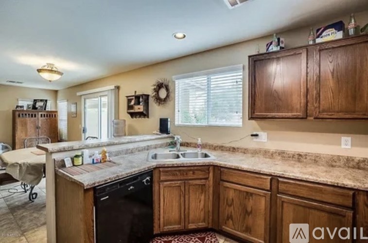 A kitchen with wooden cabinets and a granite countertop.