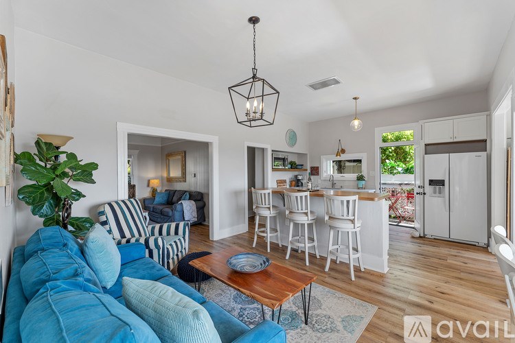 A living room with a blue couch and a wooden coffee table.