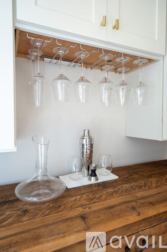 A wine glass rack with glasses hanging from it.