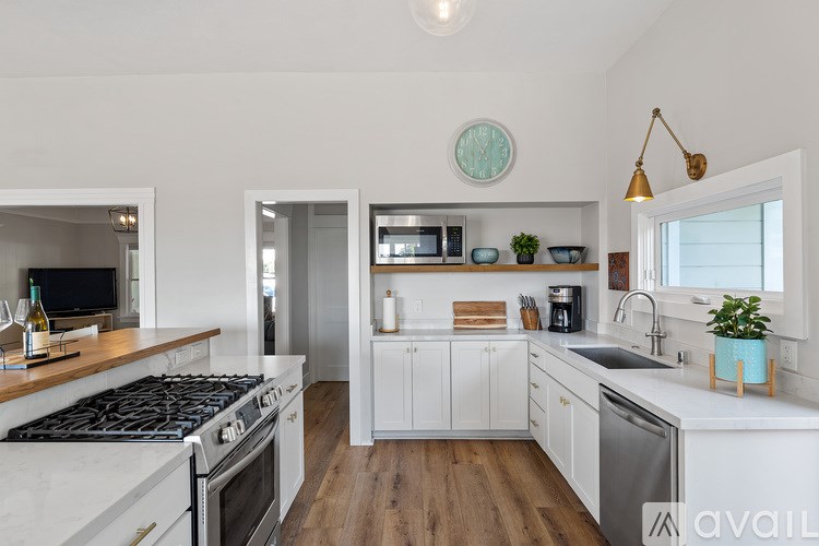 A modern kitchen with a stove top oven and a dishwasher.