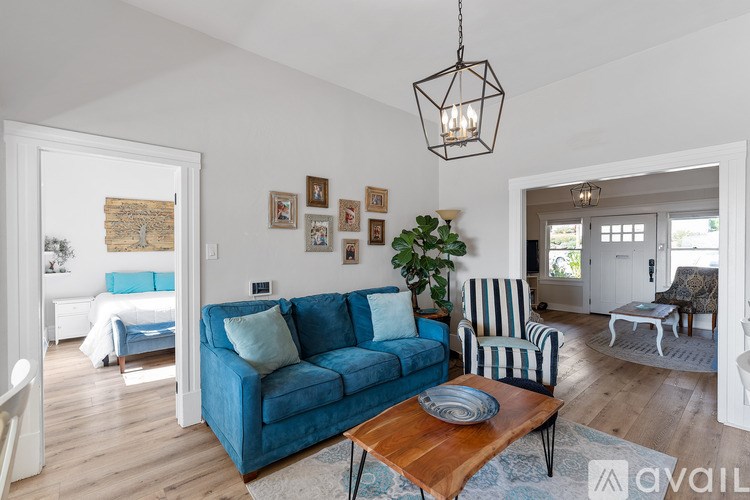 A living room with a blue couch and a wooden coffee table.